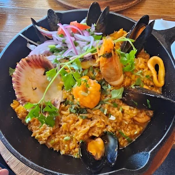 Peruvian arroz con mariscos, a seafood rice dish with mussels, shrimp, scallops, and calamari.